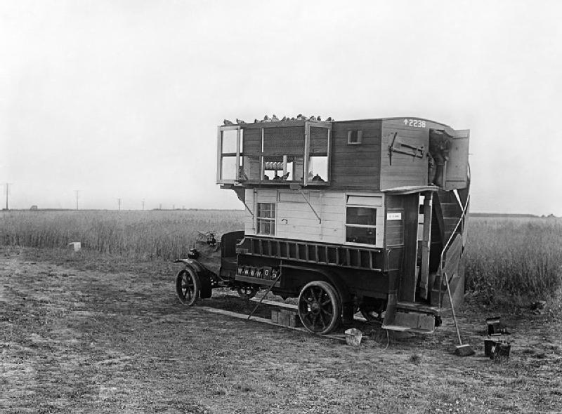 IWM Q6230 Carrier pigeons: A bus converted into a mobile pigeon loft on the Western Front, July 1916.