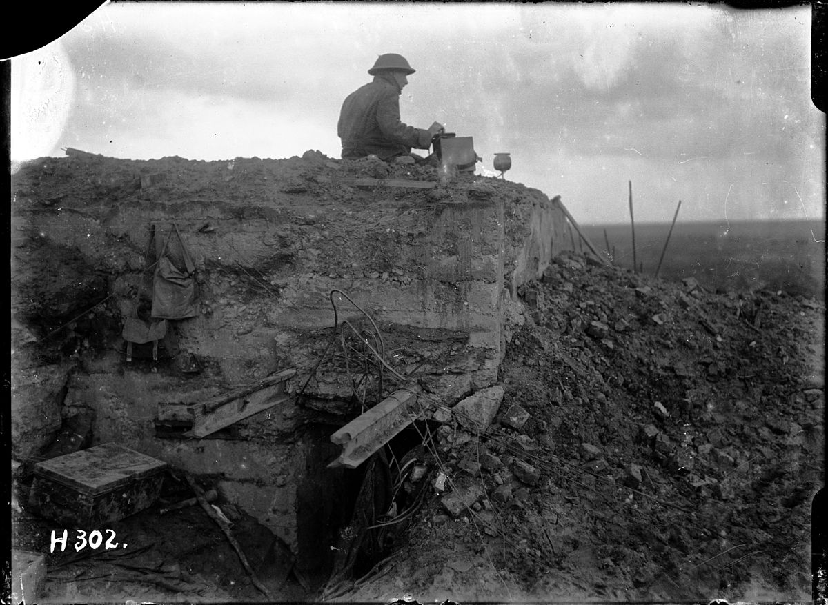 National Library of New Zealand 1/2-012945-G Unidentified New Zealand World War 1 signaller on a German dug-out, Gallipoli Farm, Belgium, 12 October 1917. Photograph taken by Henry Armytage Sanders.