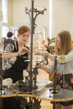 Ella (left) demonstrates the Iron Genie to a visitor.
