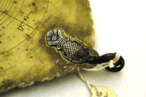 A close-up of the delicate, coin-sized fish attached to the astrolabe. 